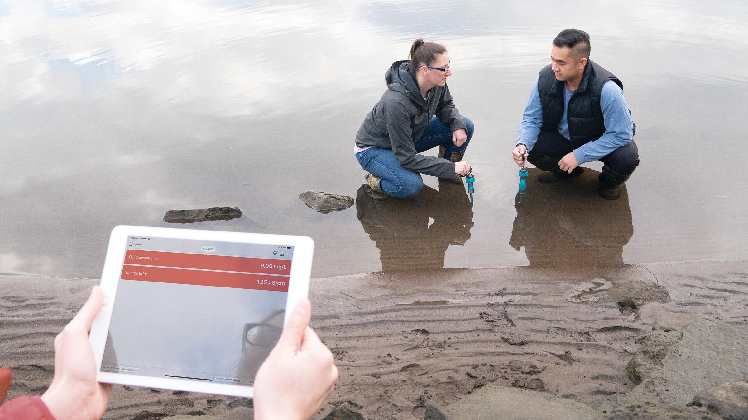 Students sampling water quality at a river's edge